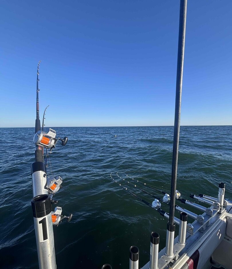 Fishing boat on water in Lorain OH with downrigger equipment and rod holders