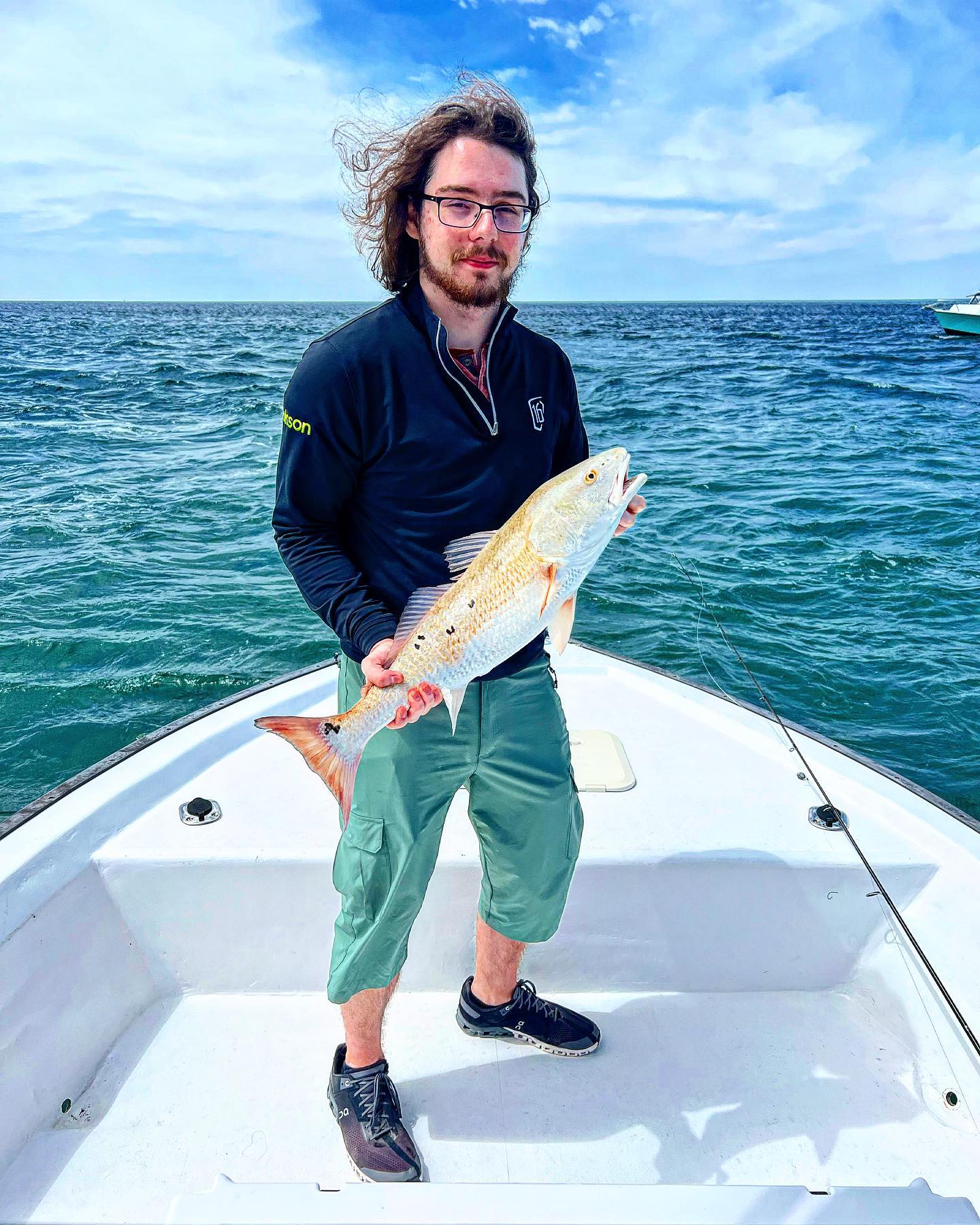 Angler catches a fish while fishing at Panama City Beach