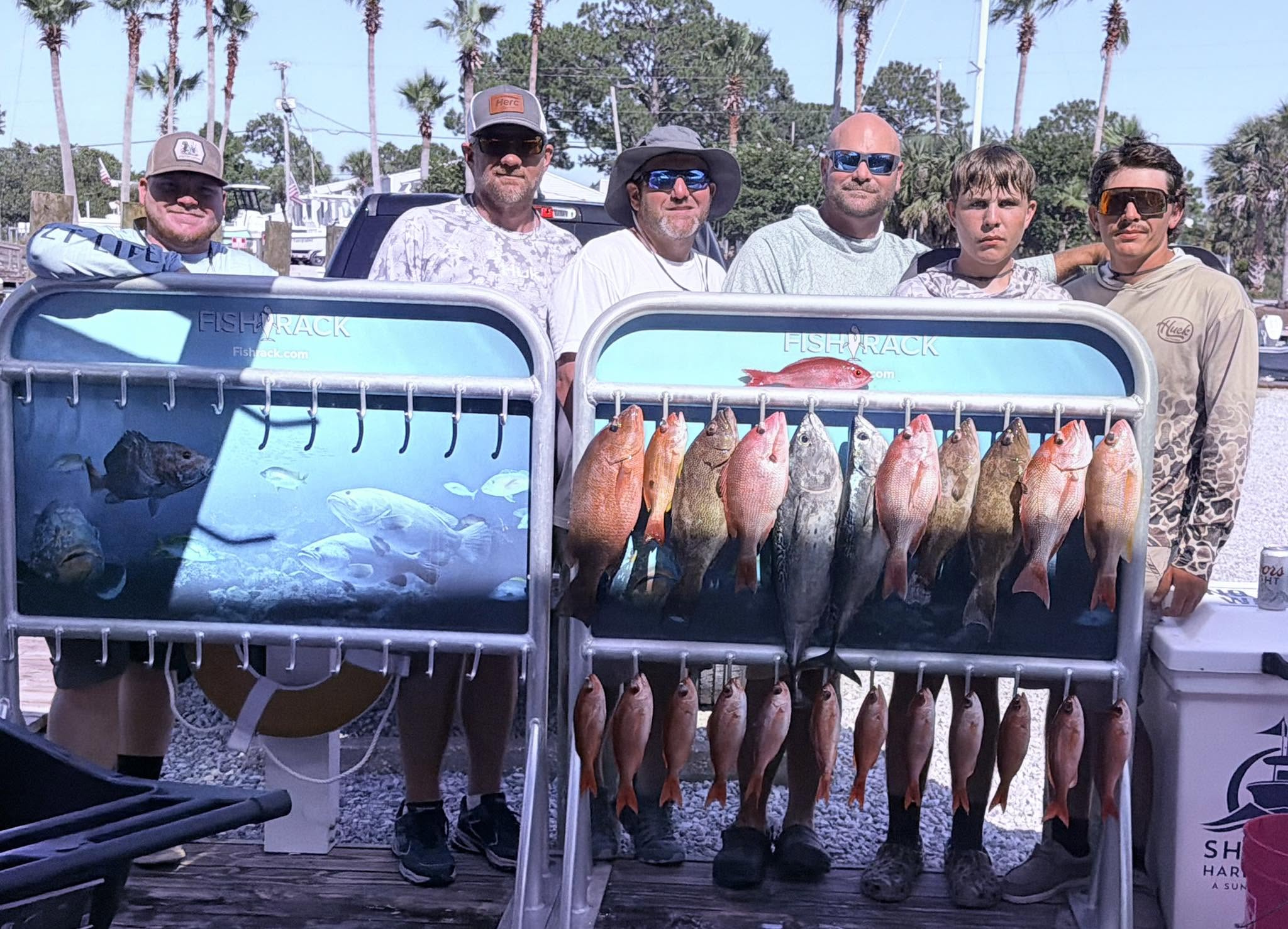 Successful fishing charter in Shalimar FL displaying red snapper and little tunny catch on fish rack