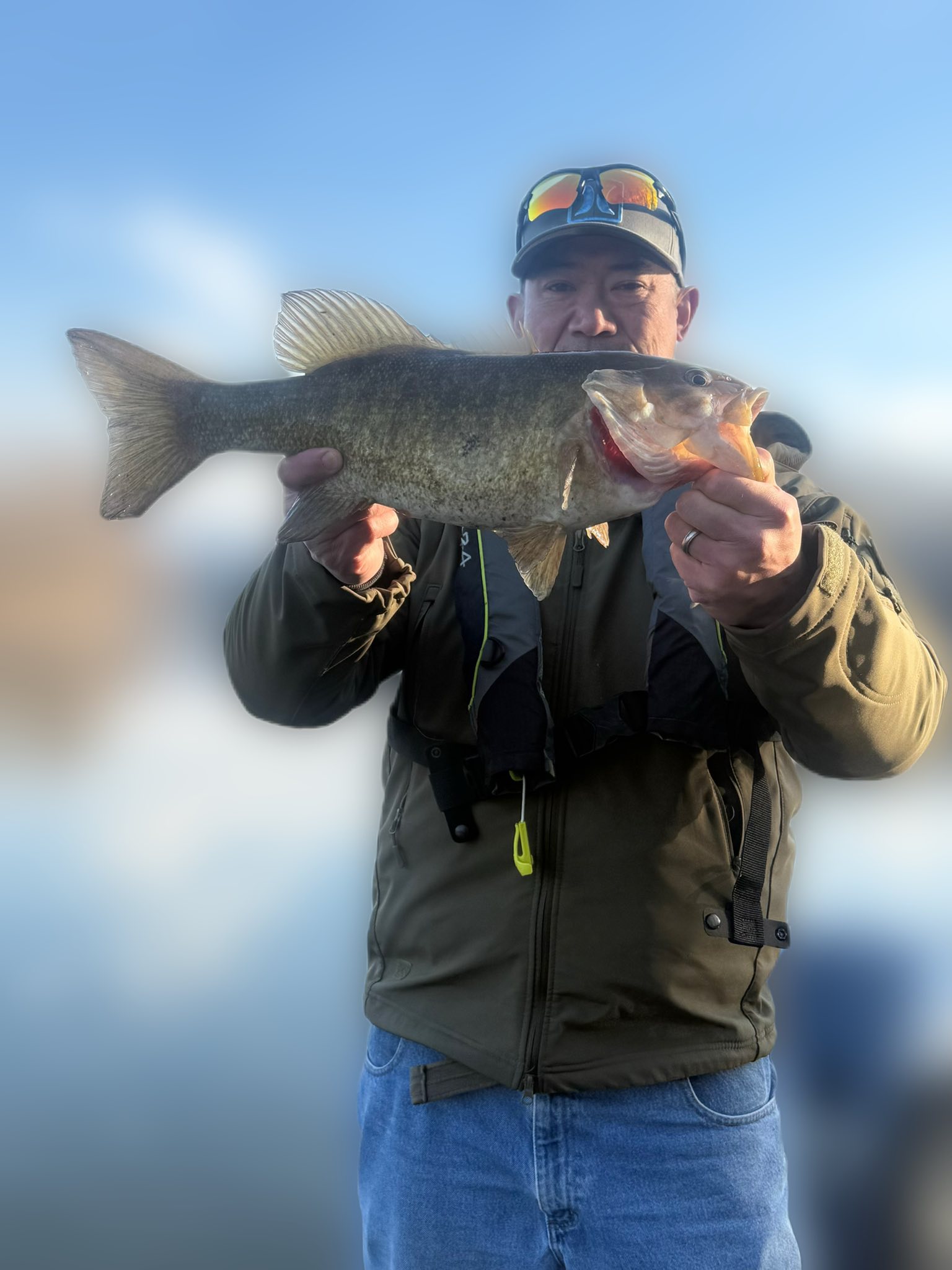 Angler holding caught bass fish in Harrisburg PA