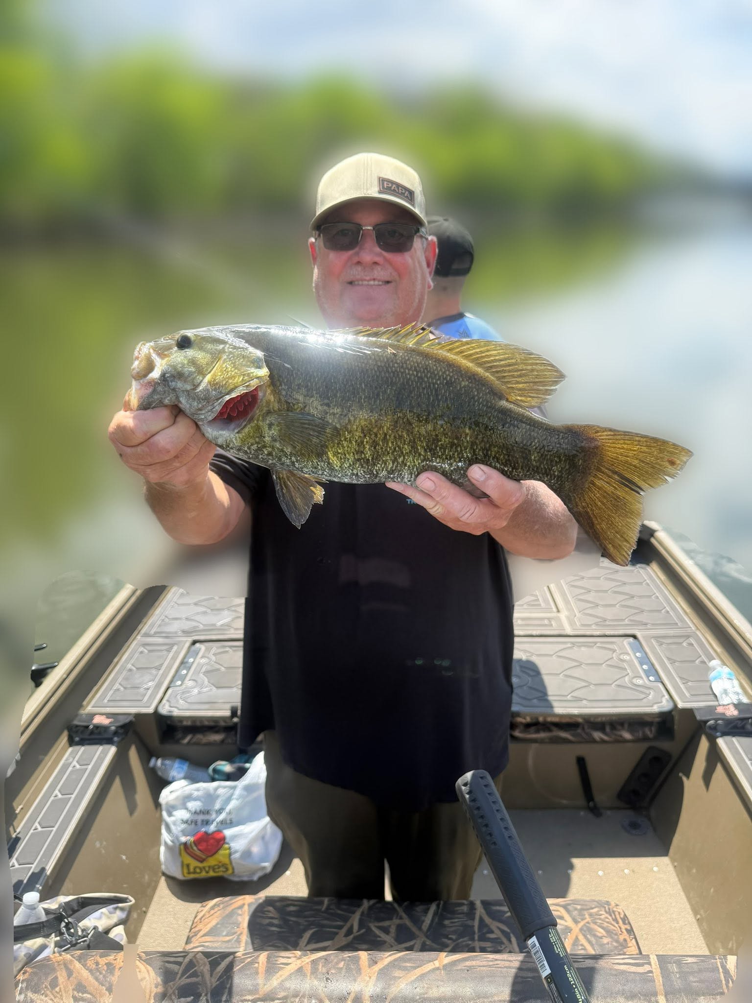 Angler holding large smallmouth bass on fishing boat in Harrisburg PA