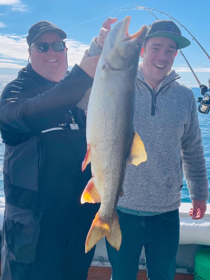 Two people fishing in Waukegan with a 29-inch fish