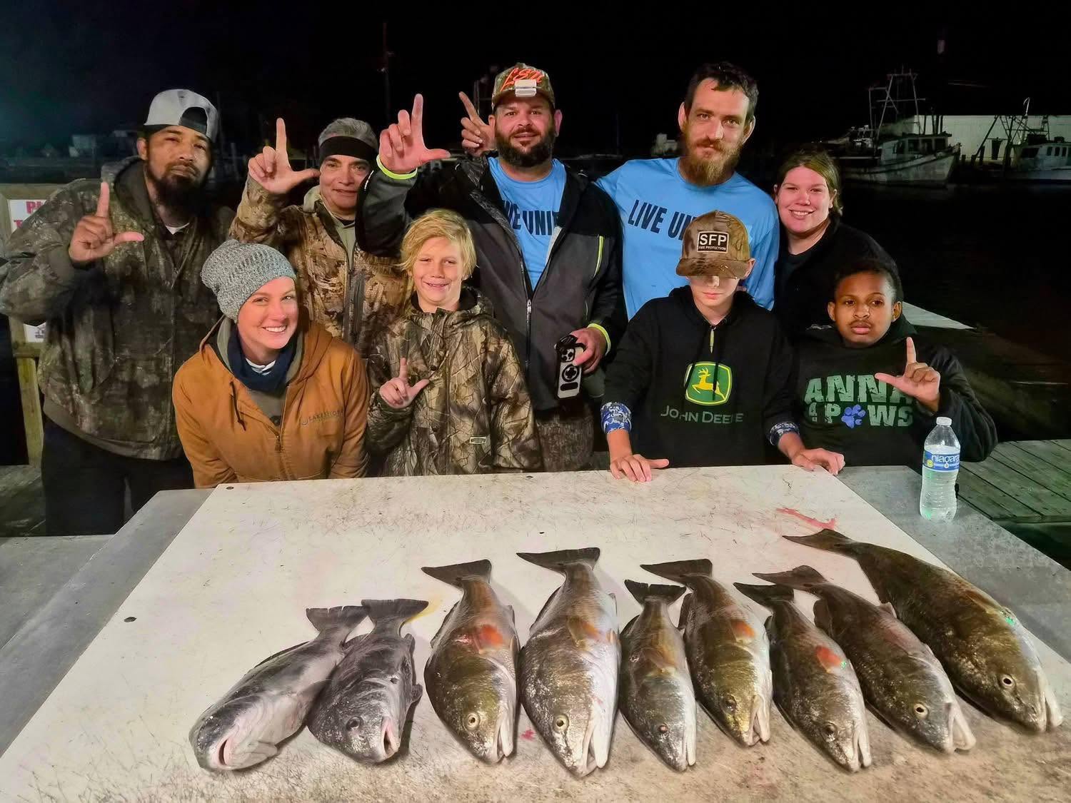 Successful redfish fishing trip in Lafitte Louisiana with multiple fish displayed on cleaning table
