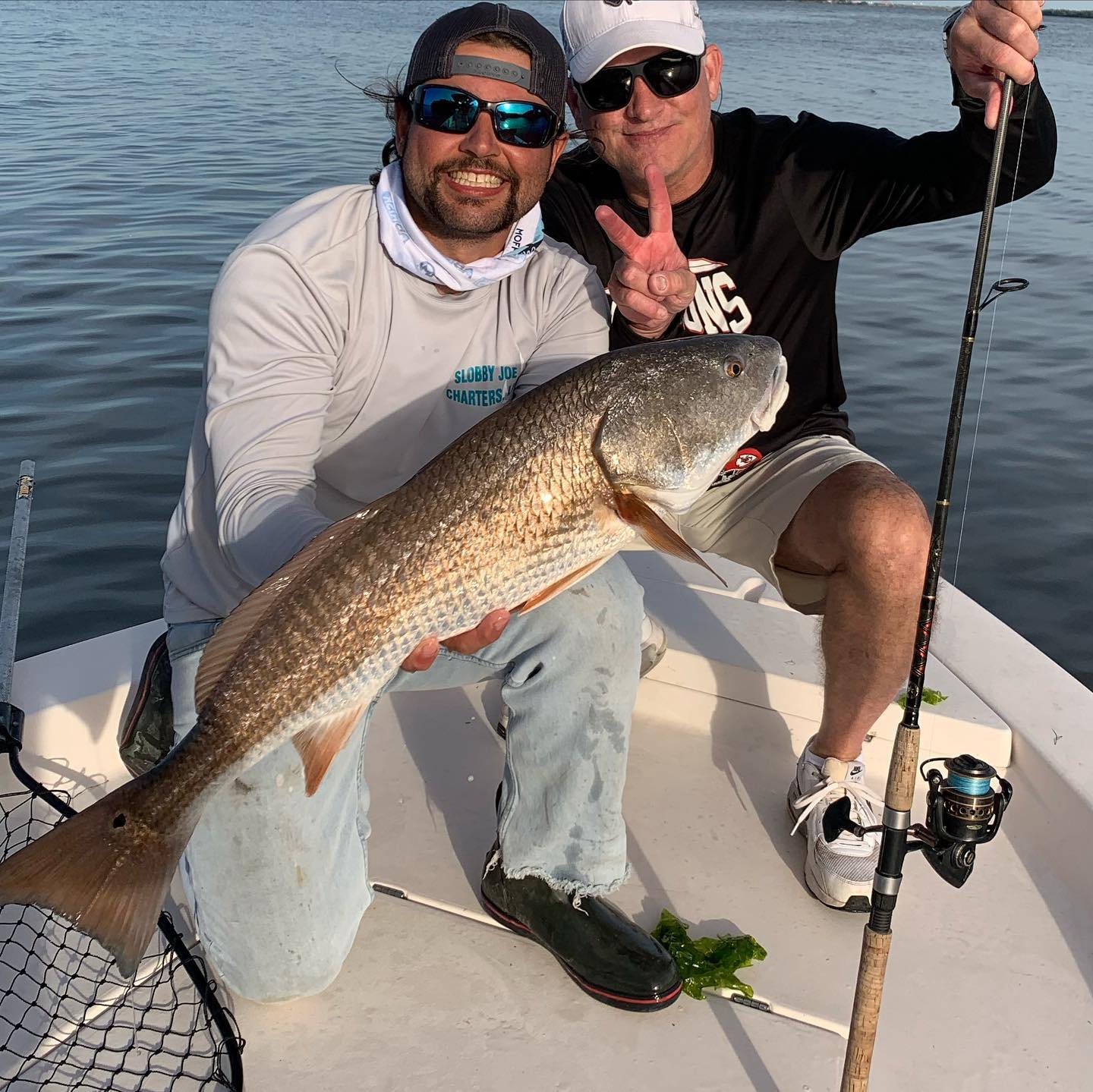 A fisherman holding a large 23-inch fish in Florida