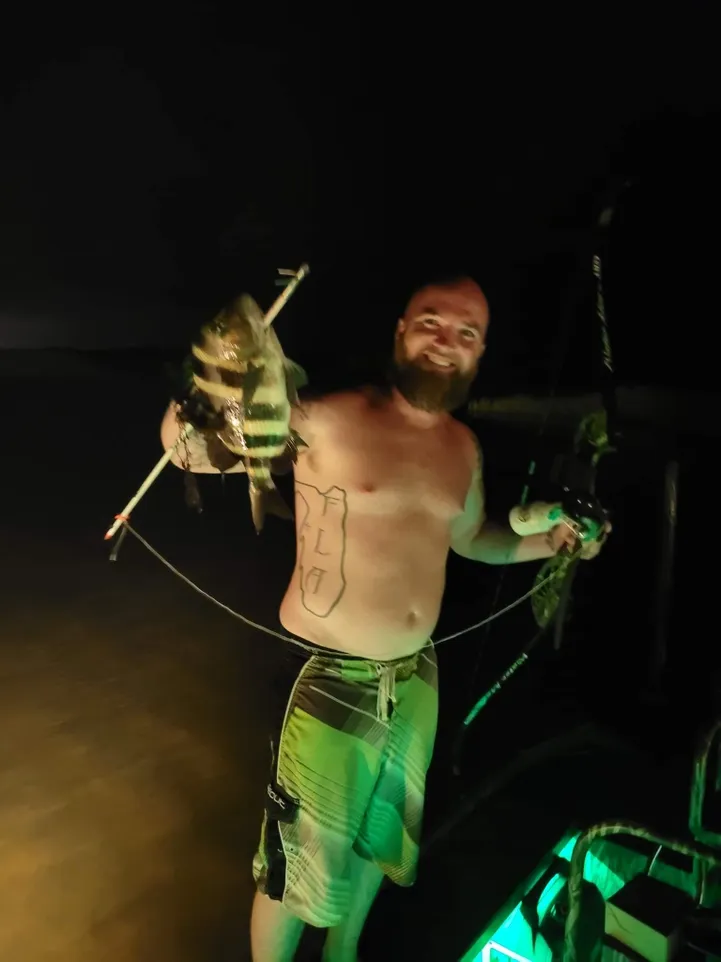 A fisherman holding a sheepshead fish in FL