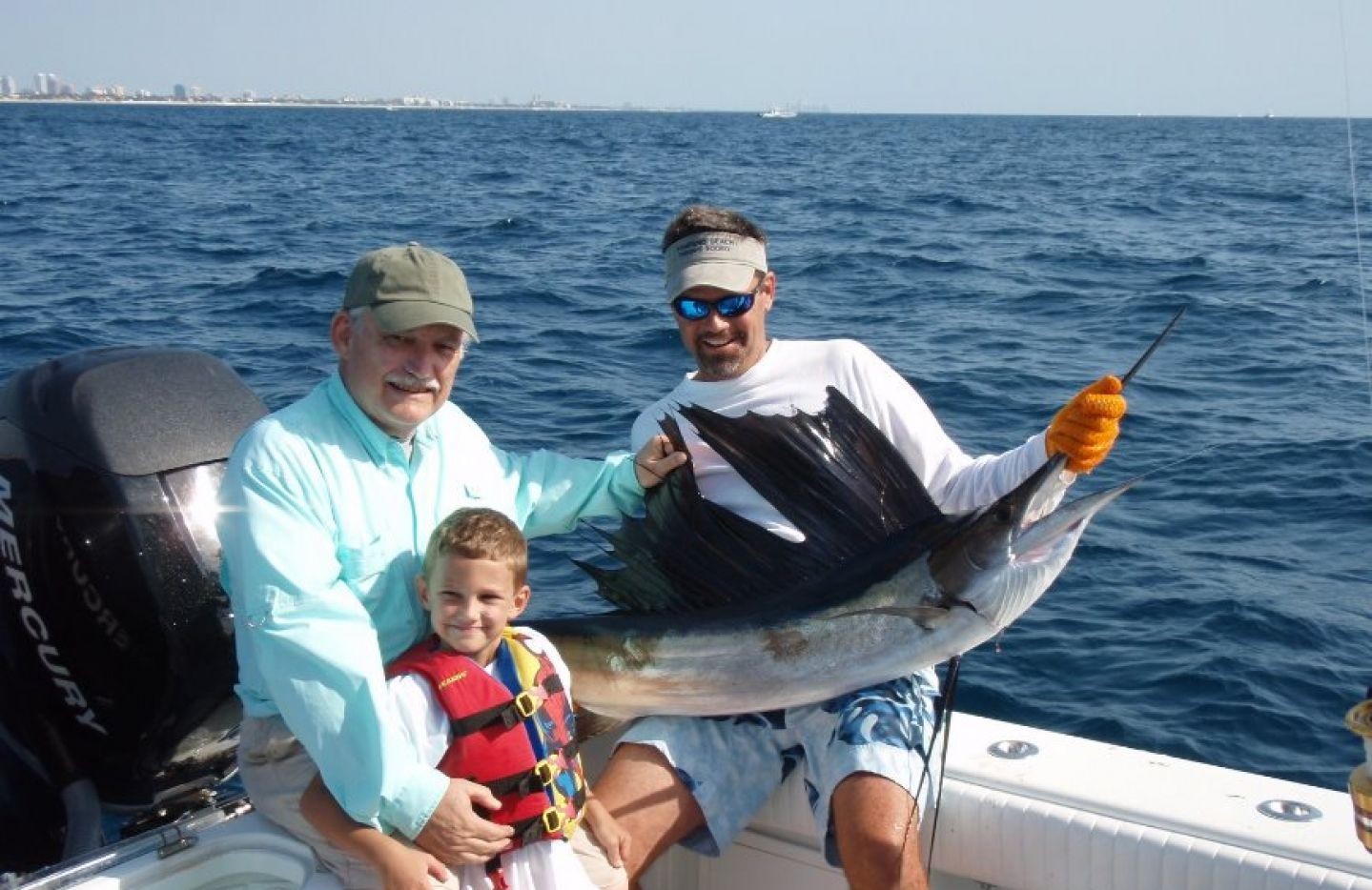 3 people fishing for an Atlantic Sailfish at Pompano Beach