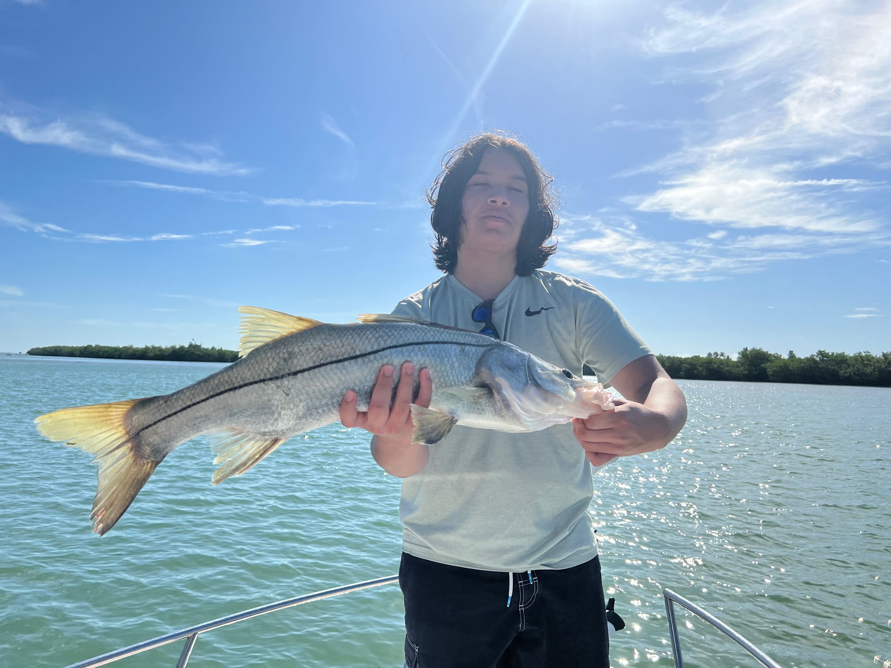 Fort Myers 6 hour offshore fishing charter boat with anglers catching snook and redfish