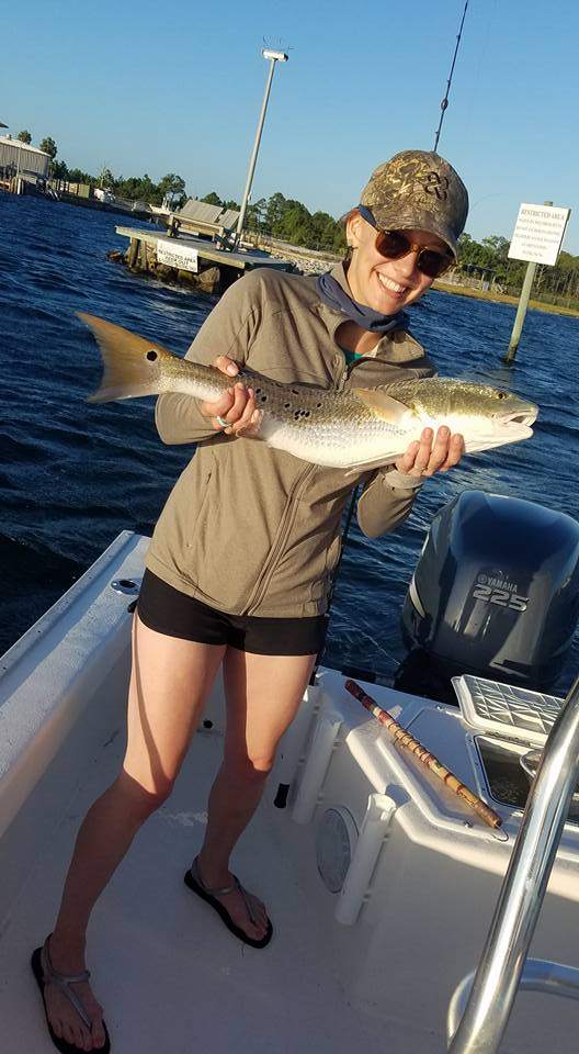 A single angler holding a 22-inch fish in FL