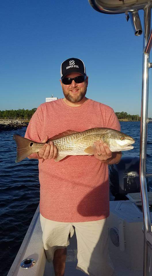 Fisherman with a large redfish, caught in FL