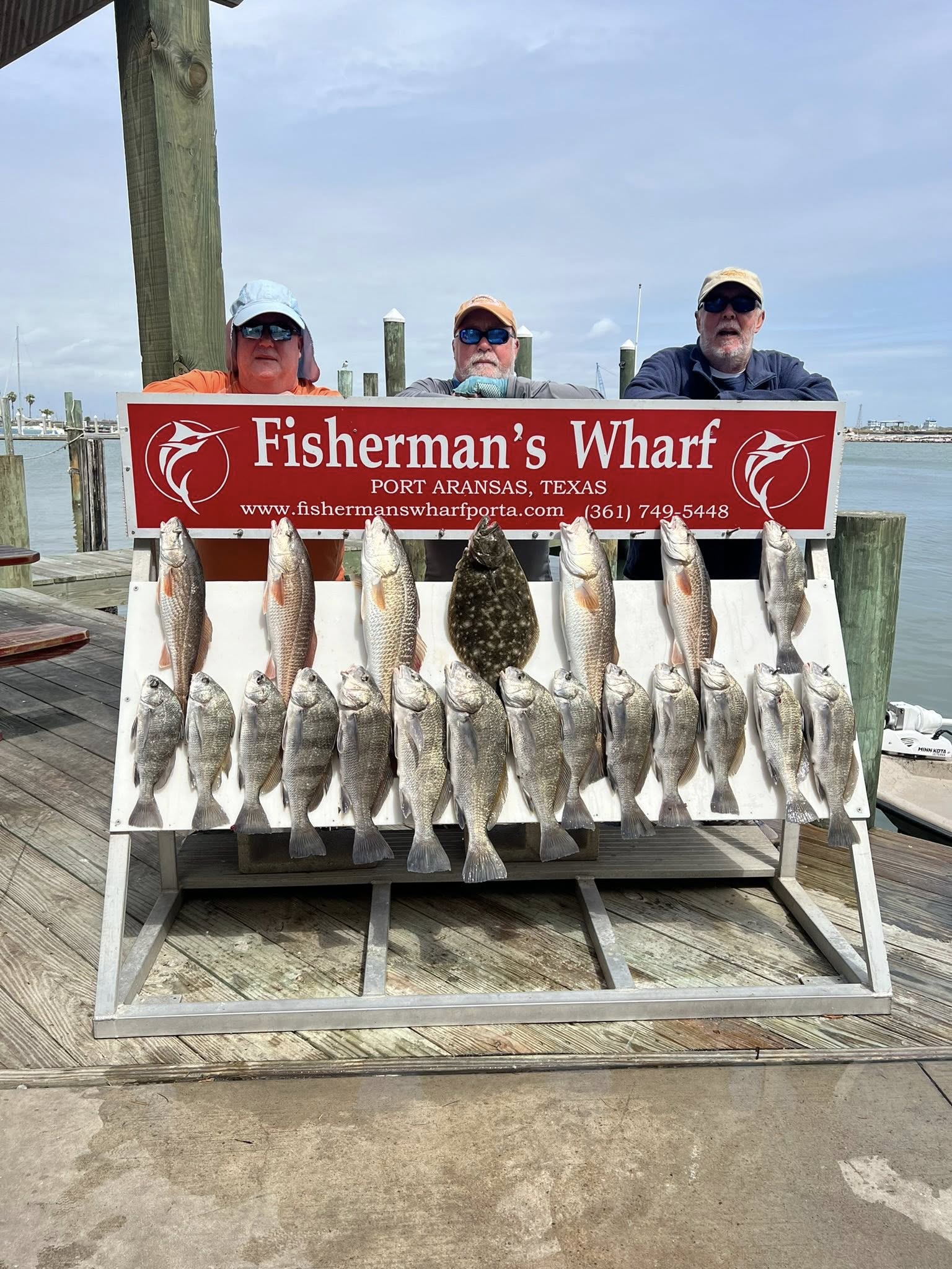 Successful fishing trip display showing Southern Flounder, Redfish, and Black Drum catch at Fisherman's Wharf in Rockport TX