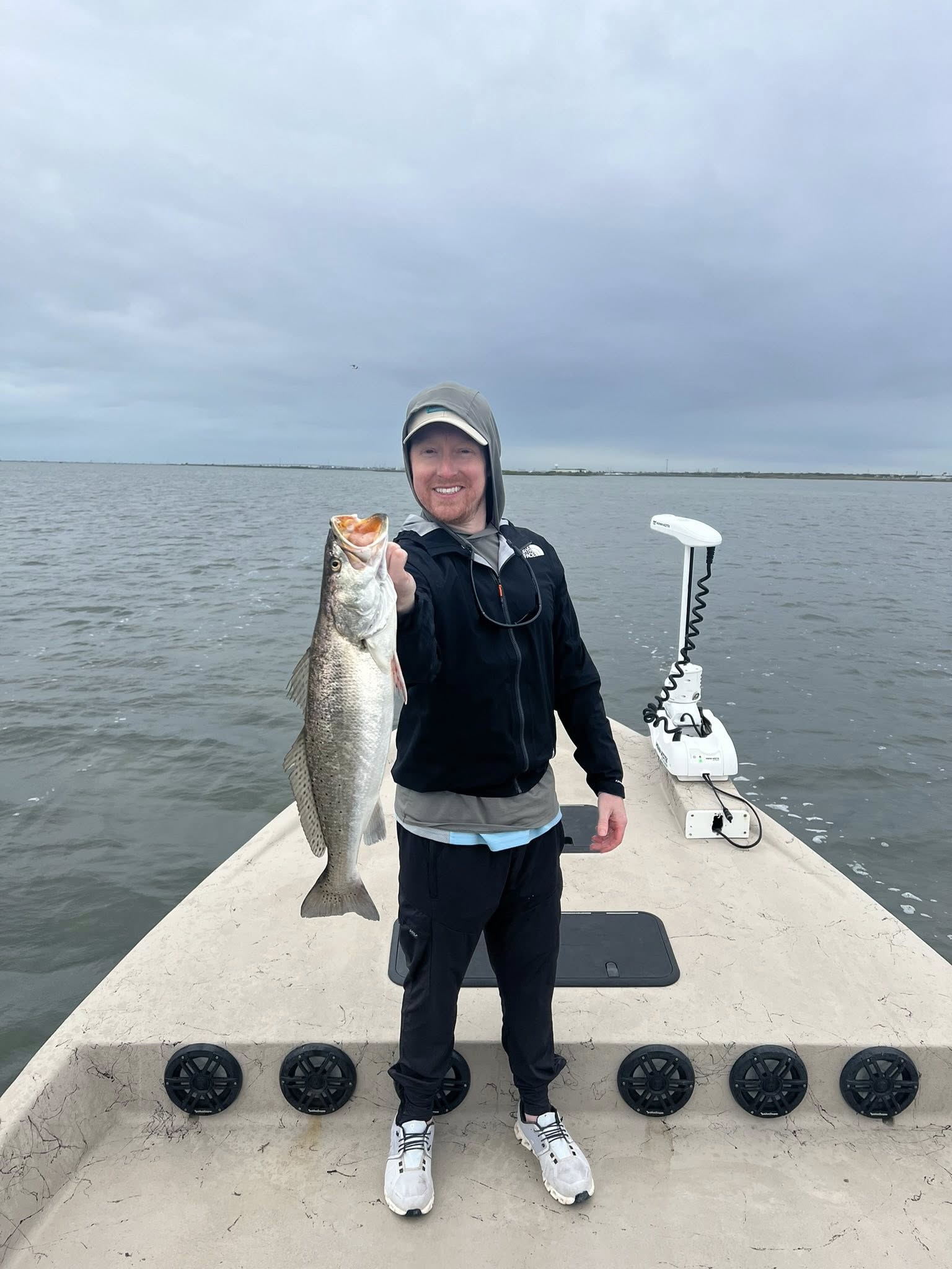 Angler holding large speckled trout on fishing boat in Rockport TX waters