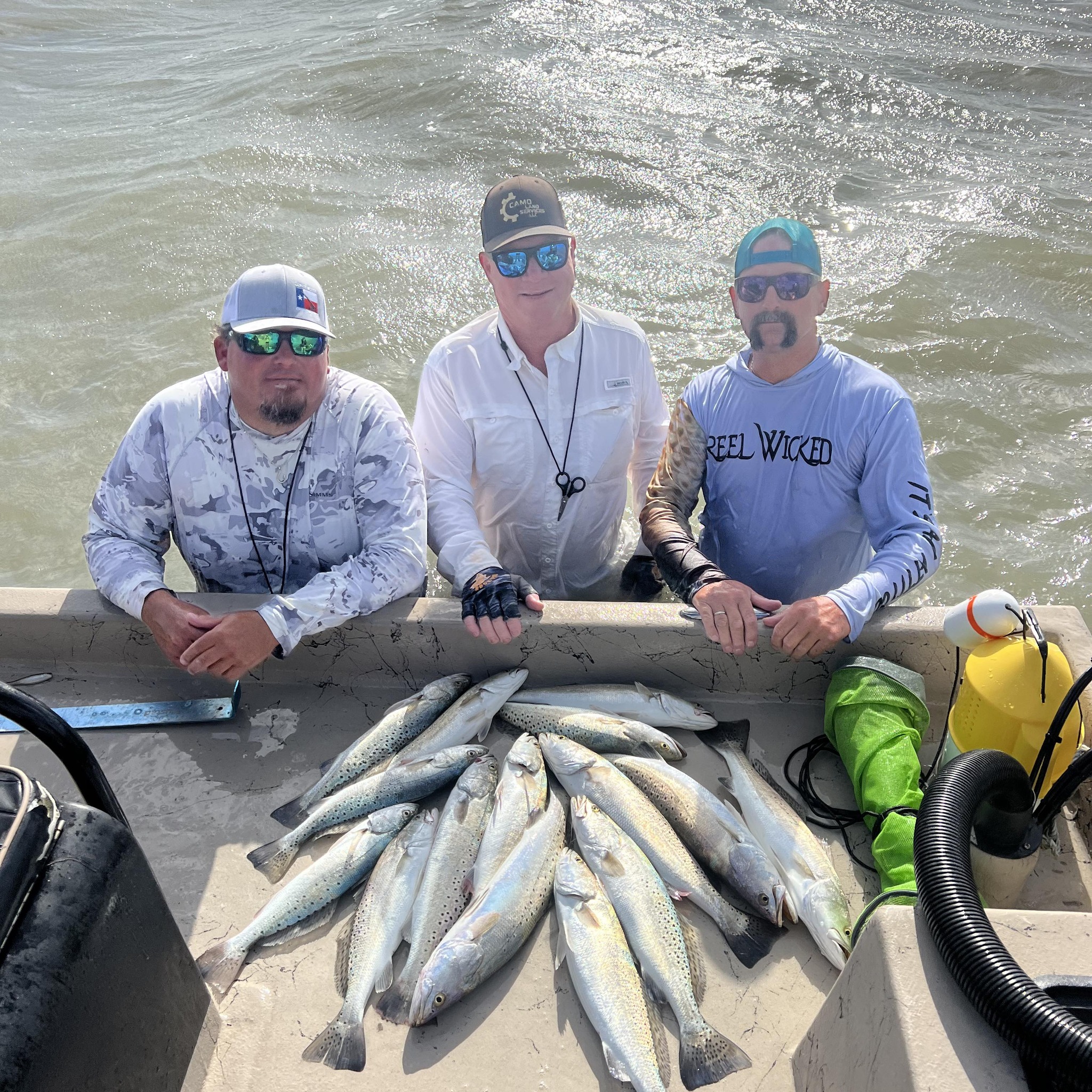 Successful speckled trout fishing trip in Rockport TX with multiple fish displayed on boat deck