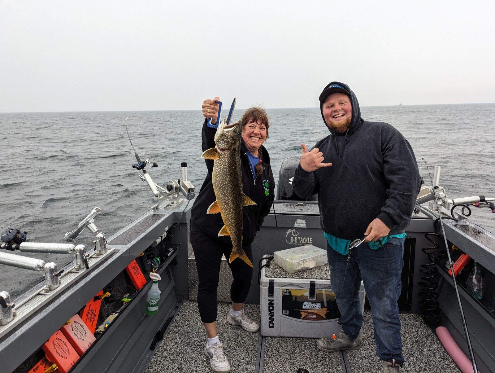 Anglers fishing in Manistee catching a 27-inch fish
