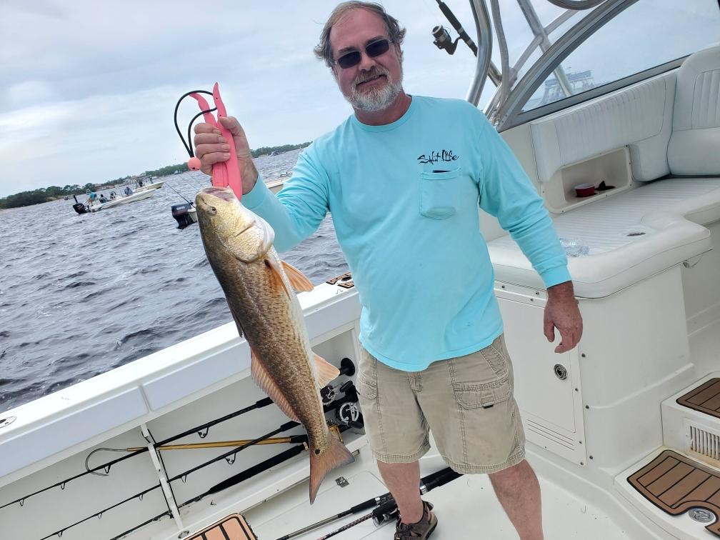 One angler reeling in a 19-inch fishing catch in FL
