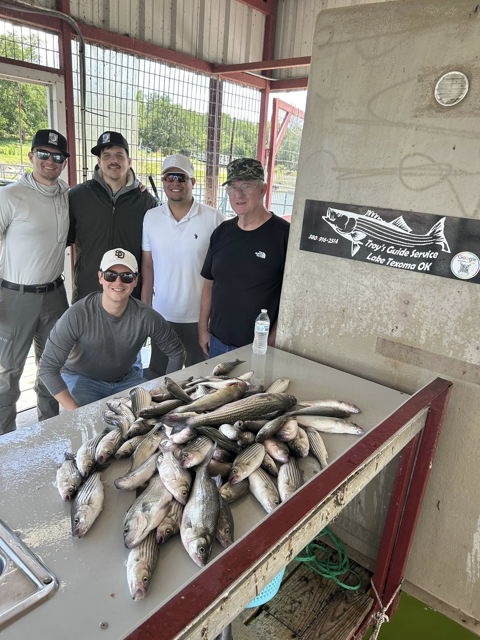 Large catch of white bass displayed on cleaning table at fishing guide service in Madill OK