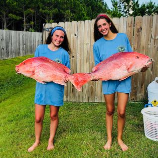 Two people fishing in the ocean at Ocean Springs