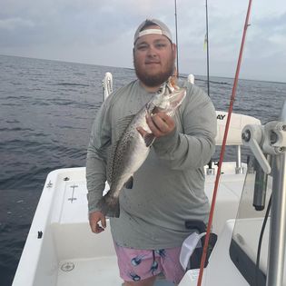A fisherman holding a 16-inch fish in MS