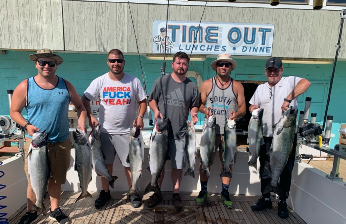 Fishing charter catch display showing Chinook salmon, Coho salmon, and Bluefish from Burt NY