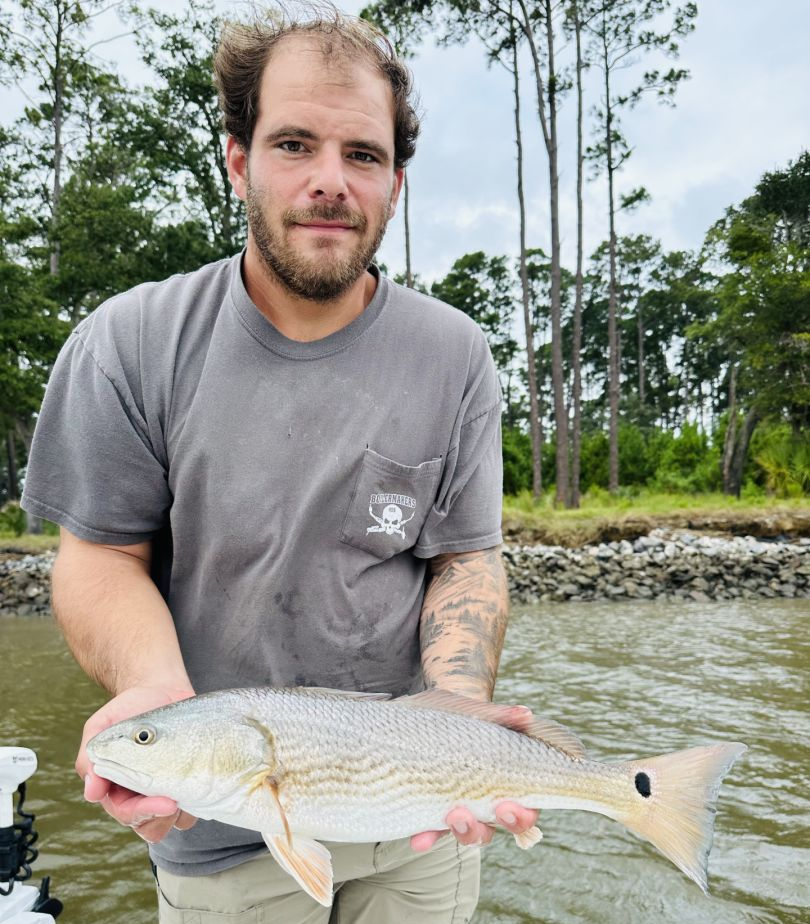 Photograph of a fisherman catching a 19-inch redfish in Savannah