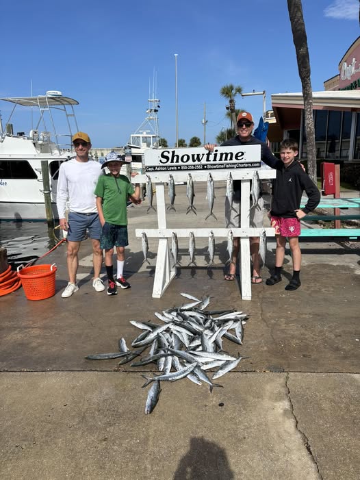 Large pile of small silver fish caught during fishing trip at Panama City Beach FL with cleaning station display