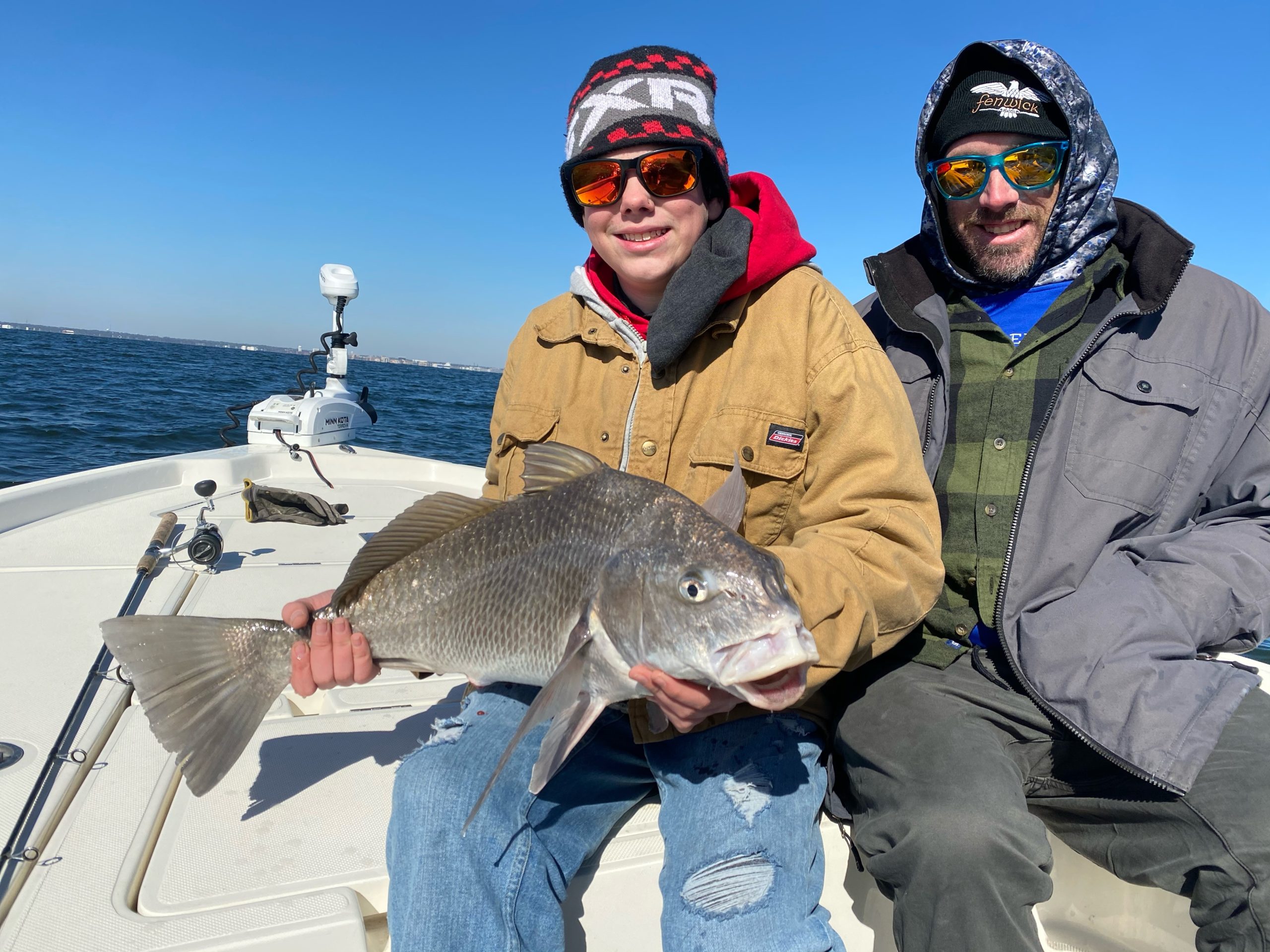 Angler holding a black drum fish in FL