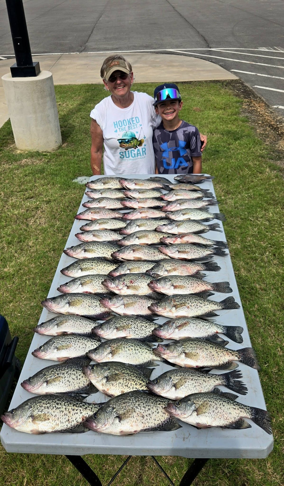 Large catch of crappie fish displayed on table after successful fishing trip in Quitman TX