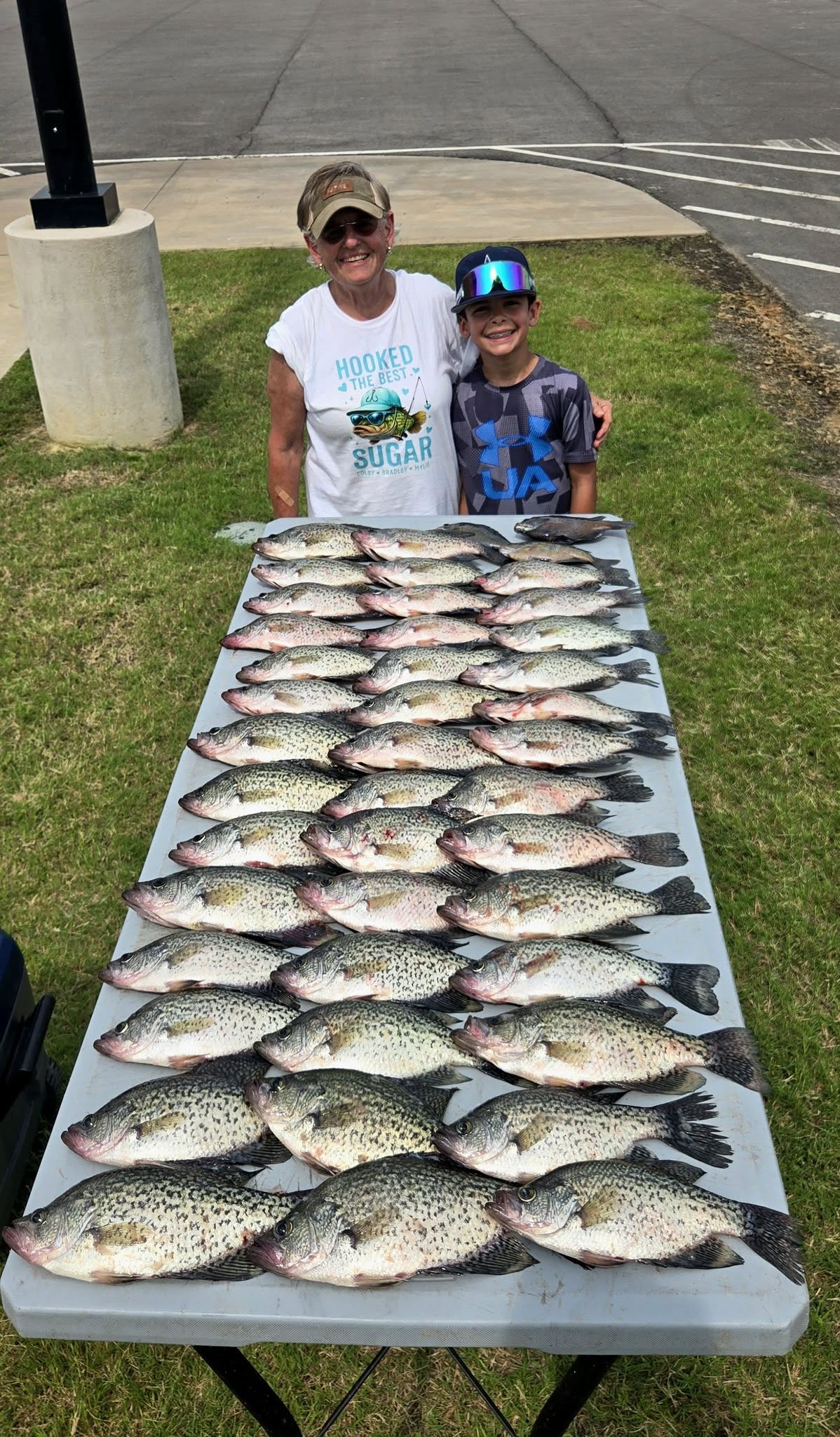 Large catch of crappie fish displayed on table after successful fishing trip in Quitman TX