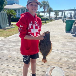 Angler holding a 14-inch fish in Savannah