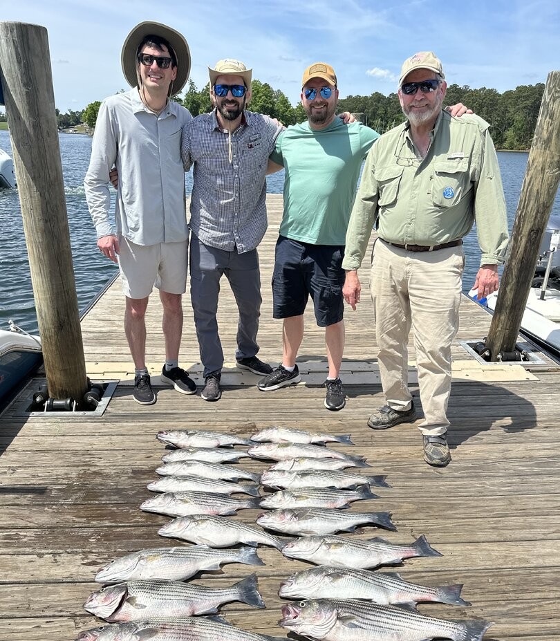 Successful striped bass and flathead grey mullet fishing trip on wooden dock in Columbia SC
