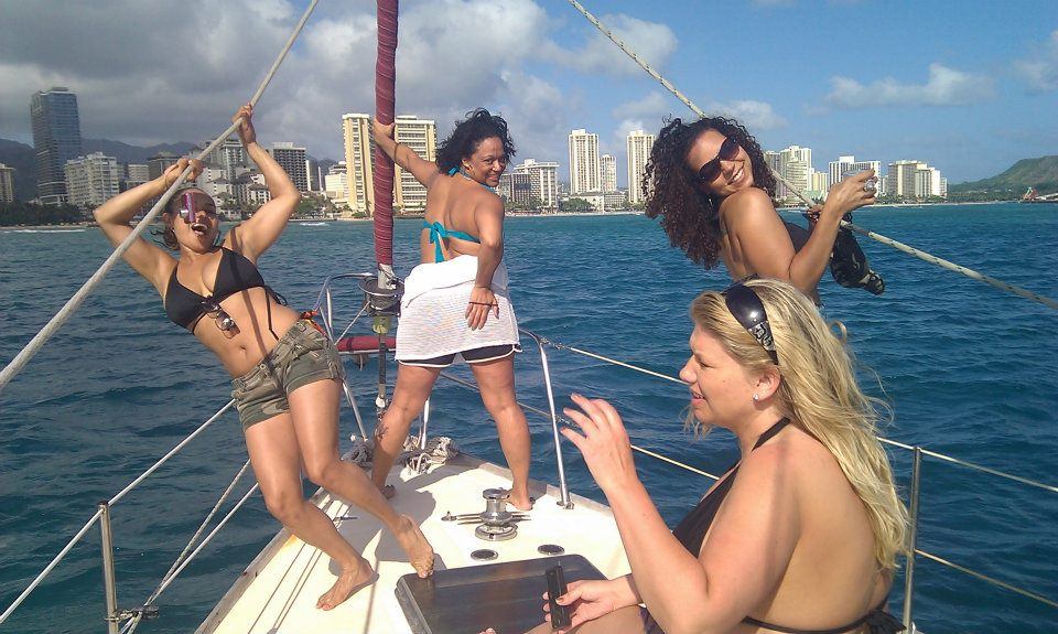Three people enjoying a scenic day in Hawaii