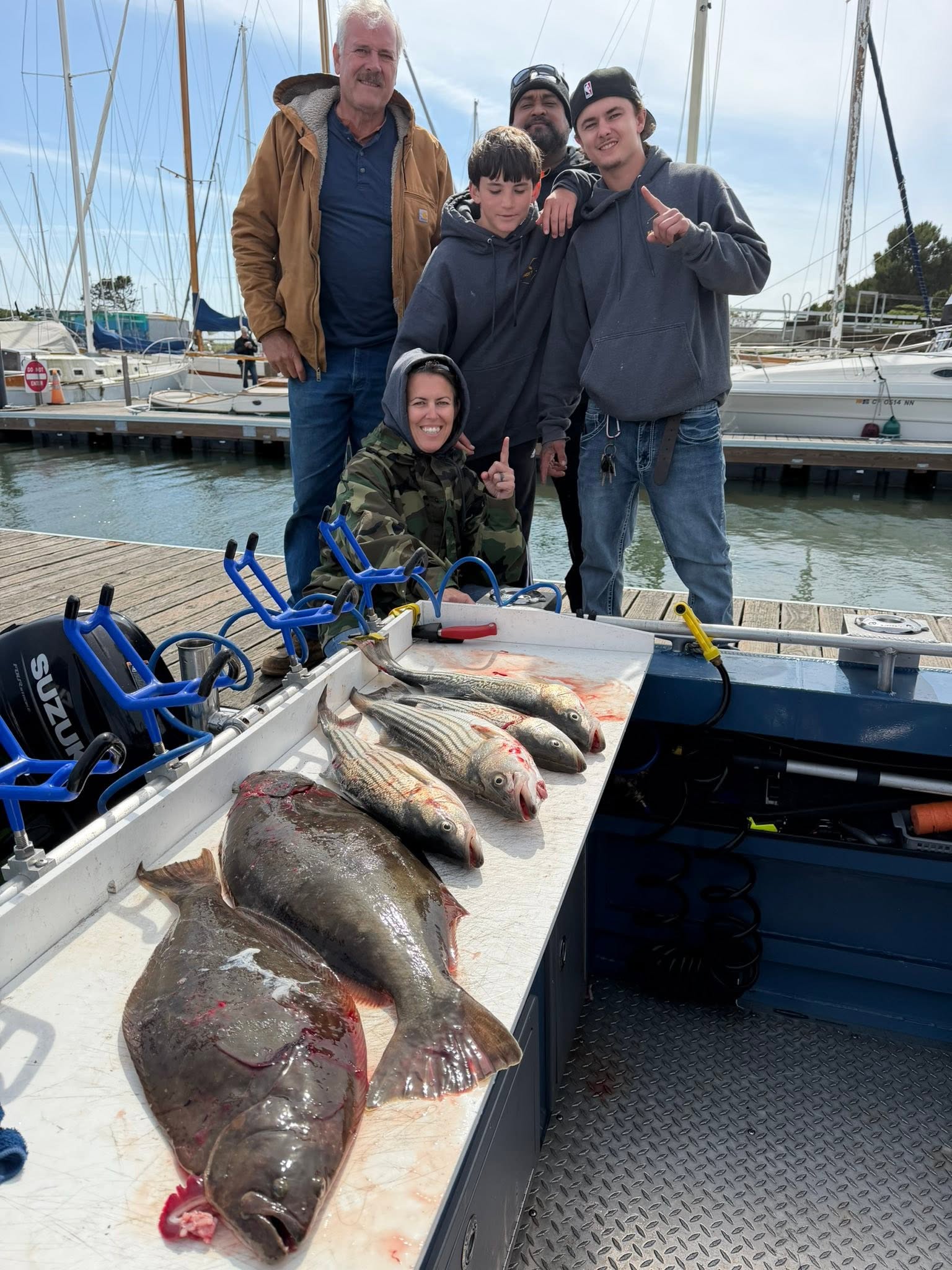 Fresh caught California Flounder and Striped Bass displayed on fishing boat deck at Sacramento marina