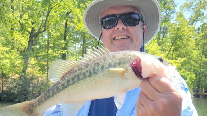 A single fisherman holding a 17-inch fish in Alabama