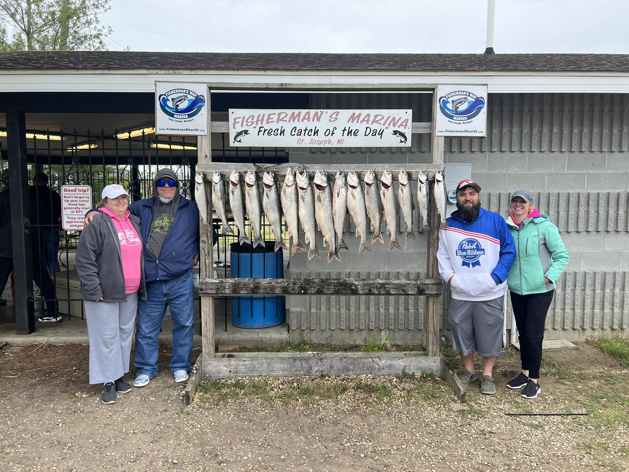 Four people fishing on the water in MI