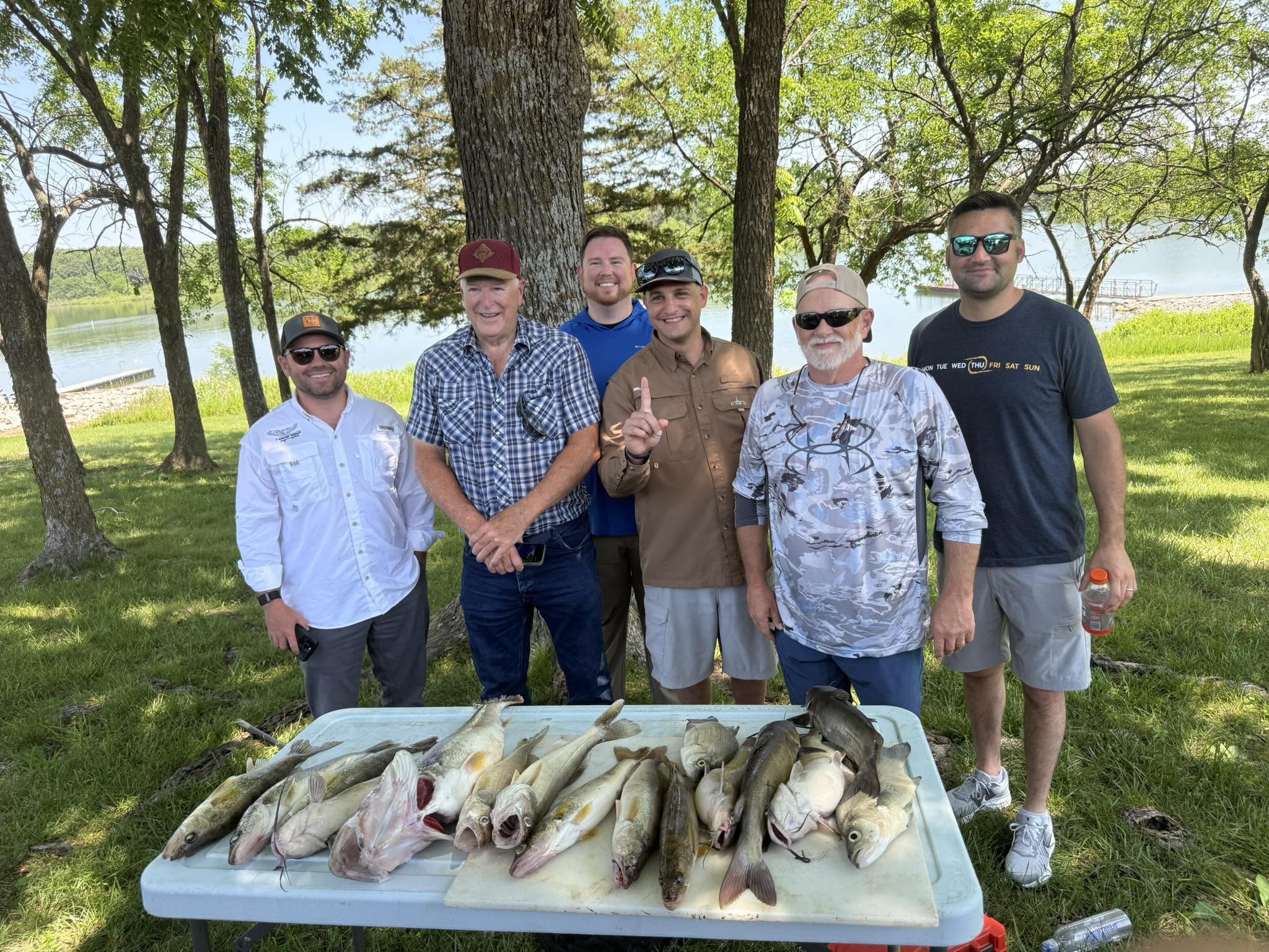 Fishing group displays fresh catch of channel catfish and walleye on cleaning table in Branson MO