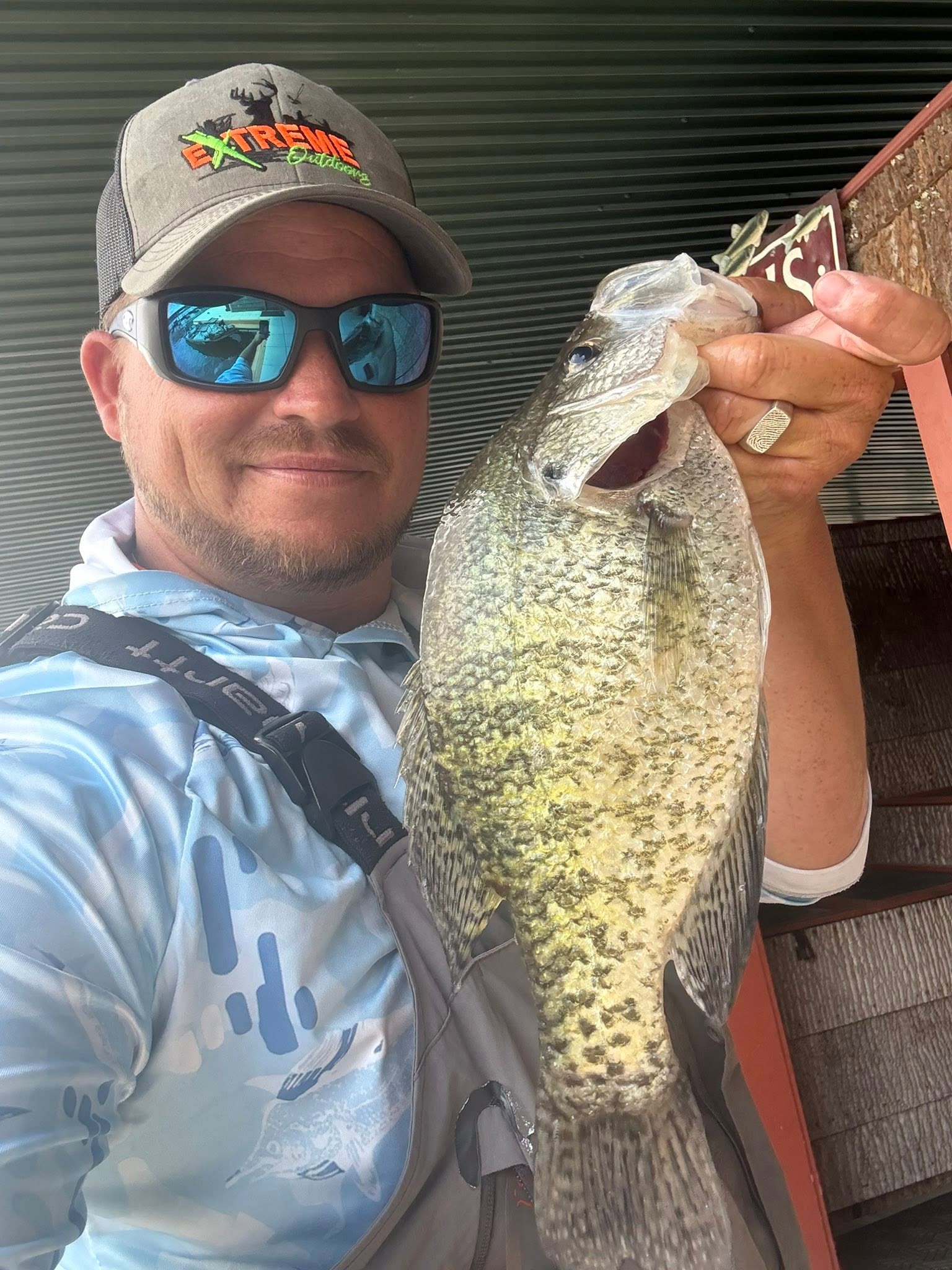 Freshly caught fish being held up in Branson MO fishing trip