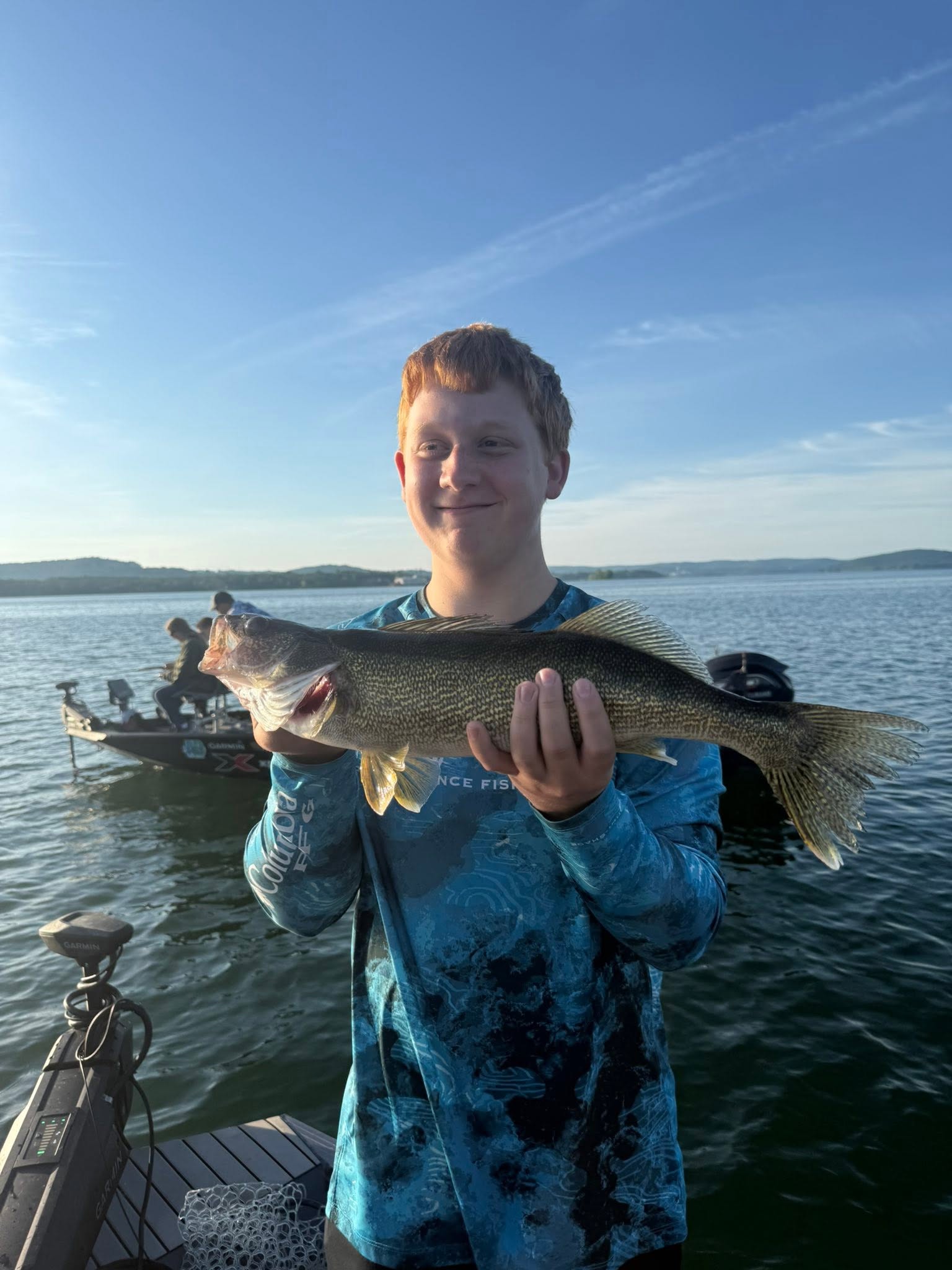 Freshly caught walleye being held up on fishing boat in Branson MO