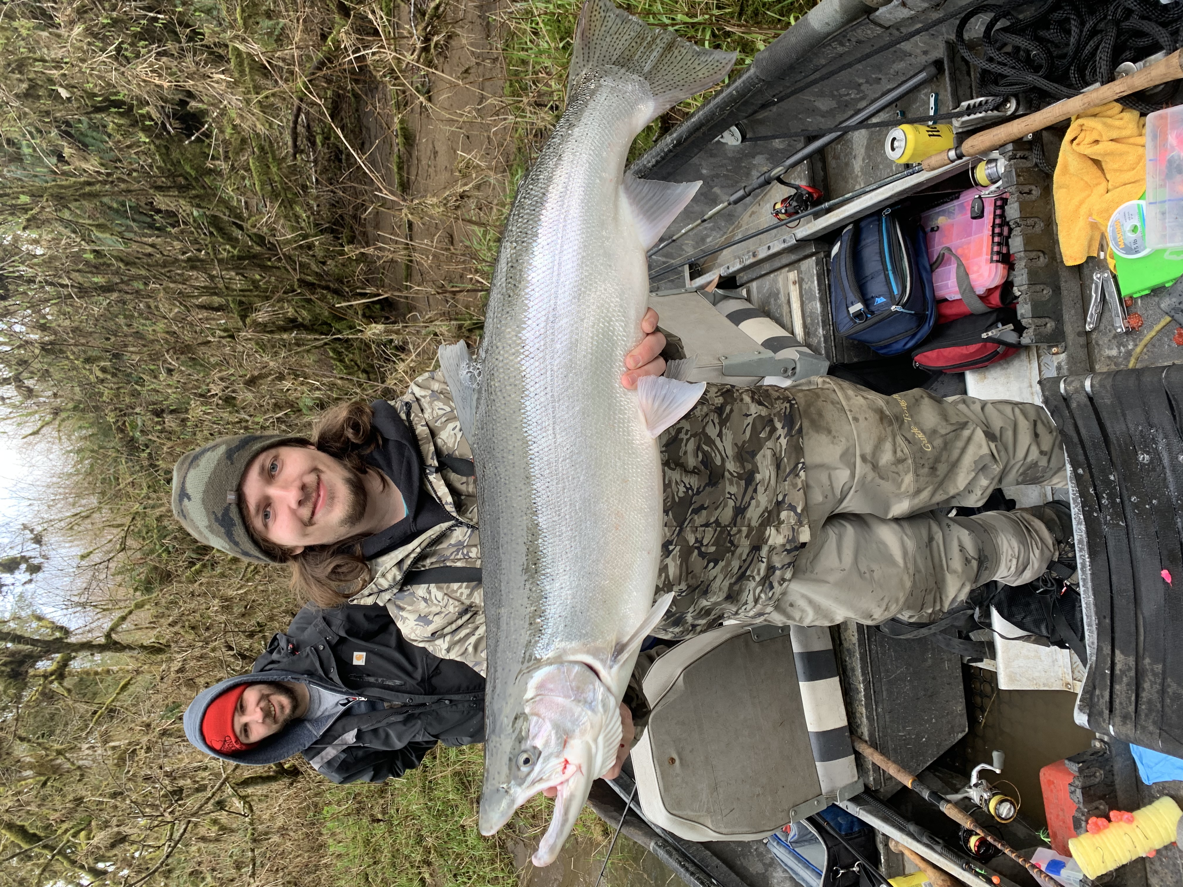 Angler holding a large rainbow trout in Salem