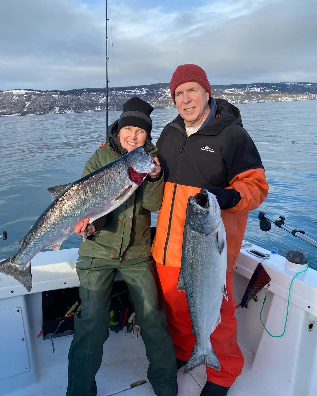 Two fishermen with a catch of large fish in Homer