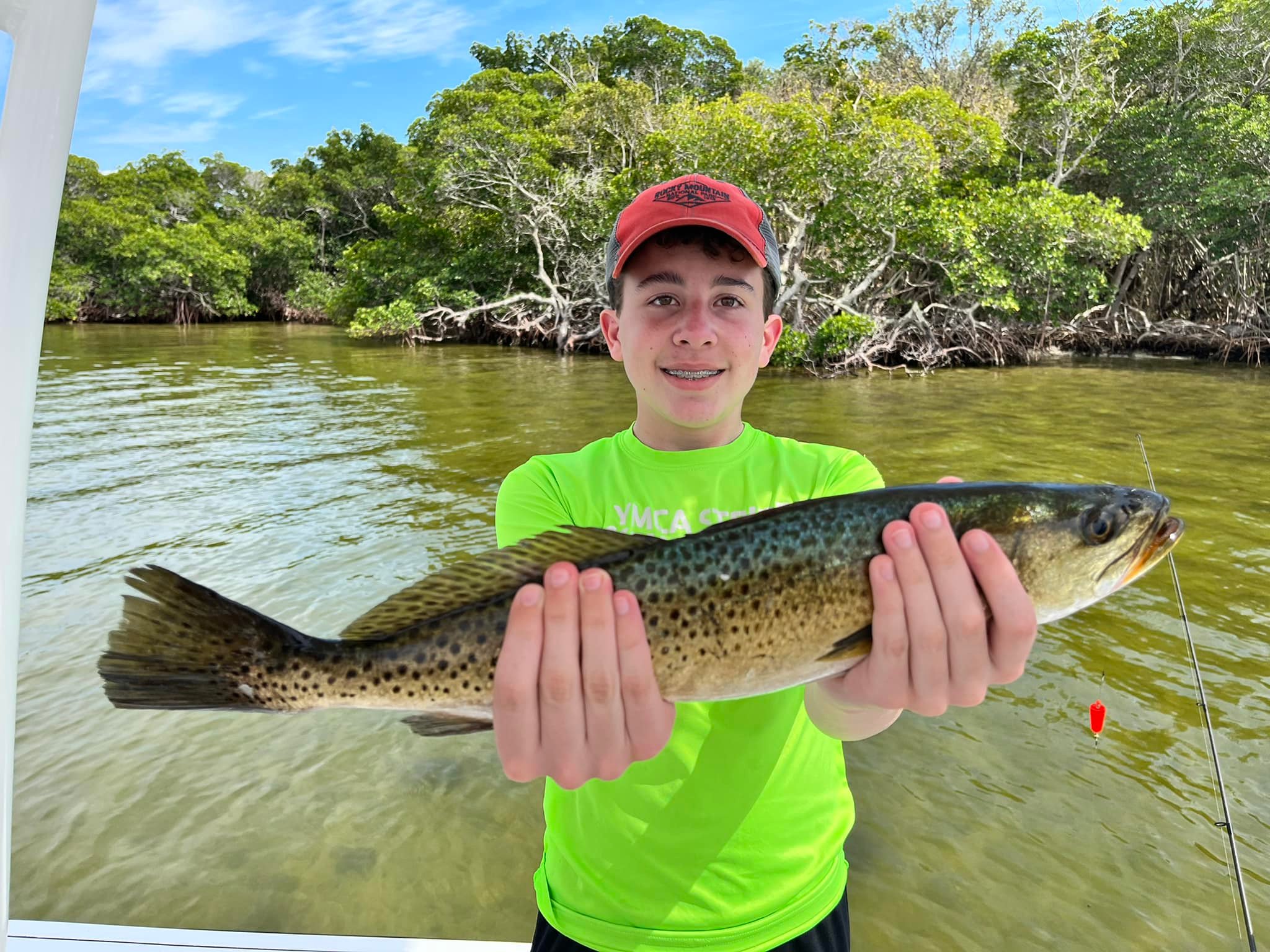 A fisherman with a spotted weakfish caught on Captiva Island