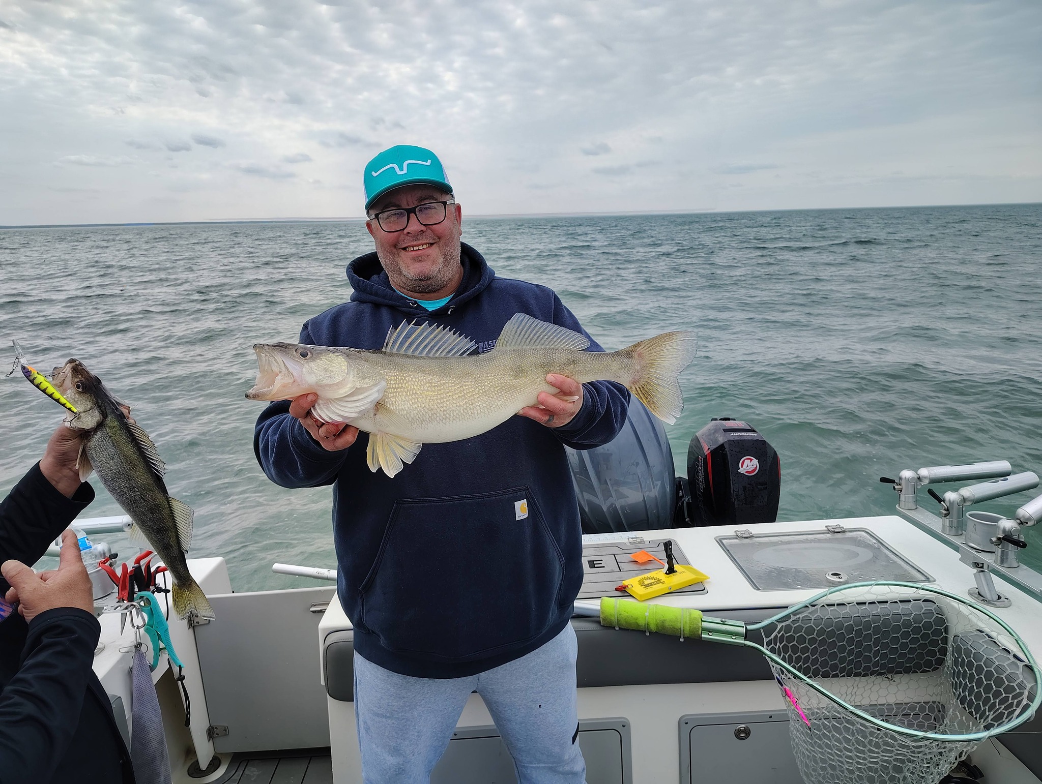 Walleye fishing success on Lake Erie at Geneva-on-the-Lake OH with two large walleye caught on boat