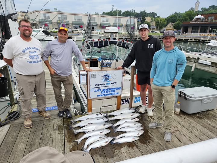 Successful fishing charter showing multiple caught fish displayed on dock in Port Washington WI