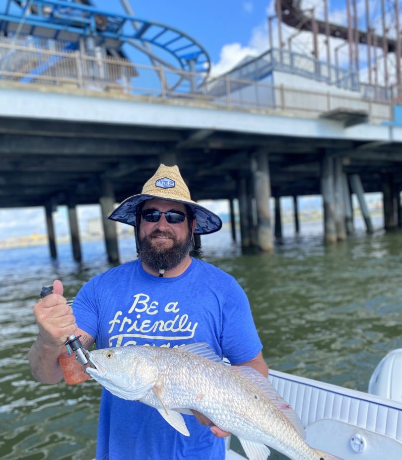 Successful angler holding a 21-inch catch in Galveston
