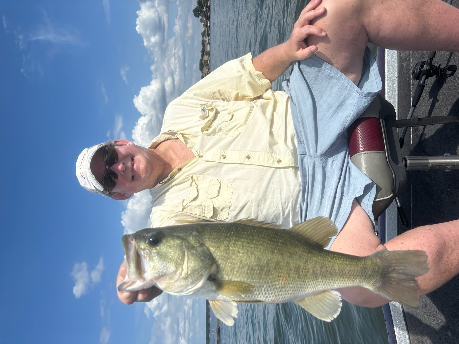 Angler holding large bass fish on boat in Willis TX