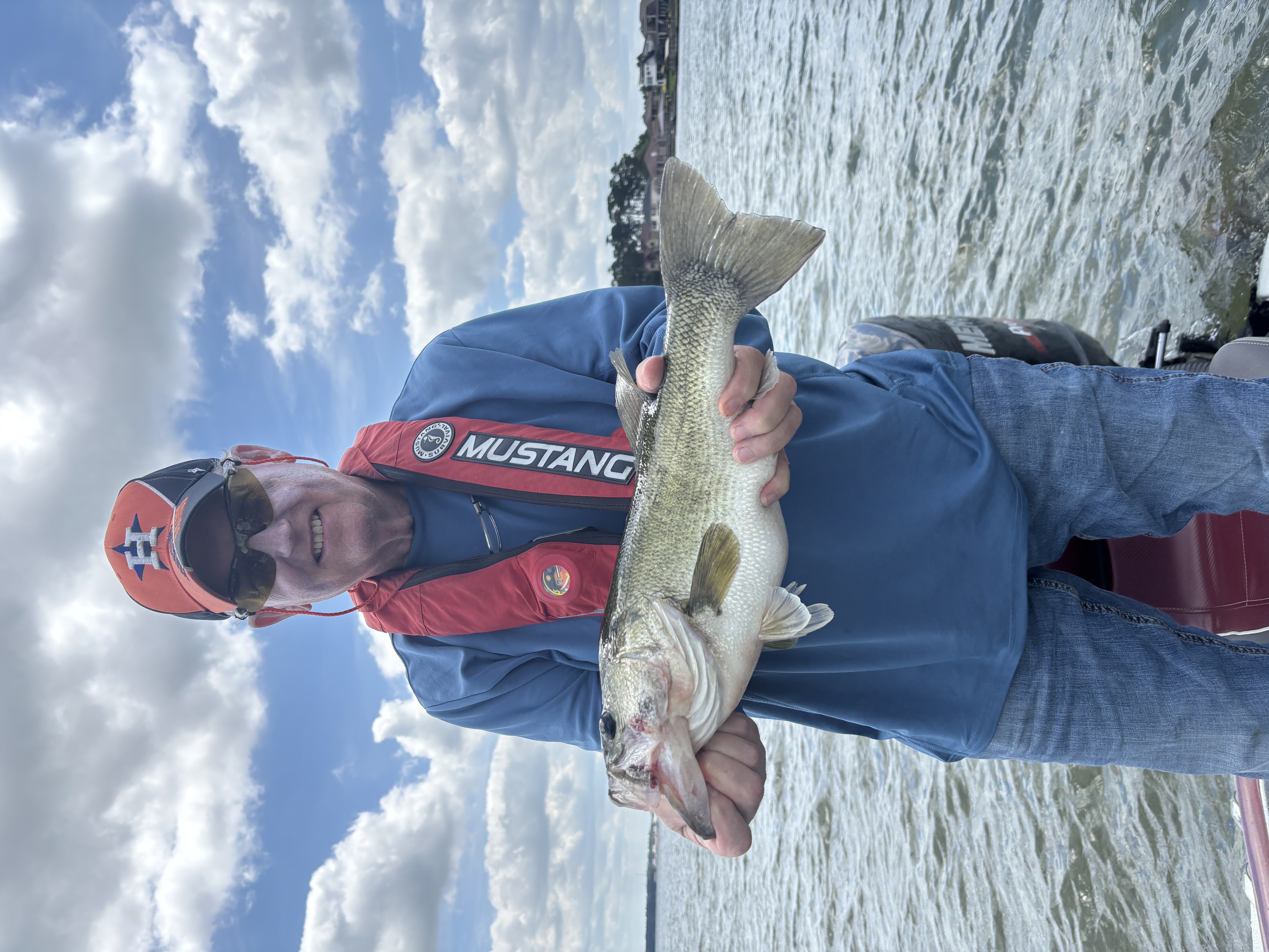 Angler holding freshly caught fish on lake in Willis TX
