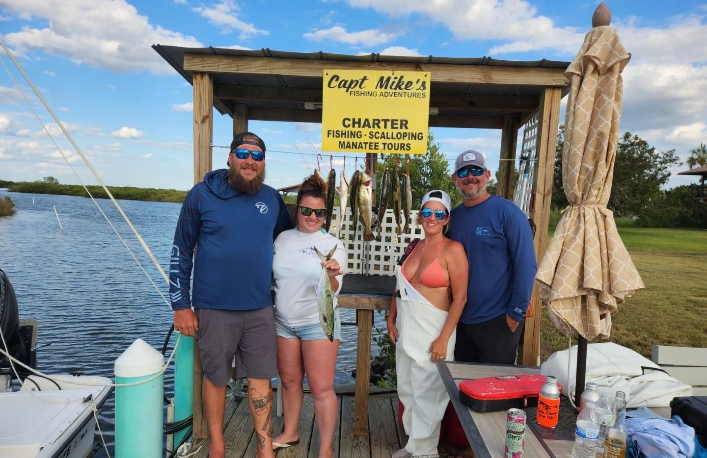 Fishing charter group displaying catch of fish at cleaning station in Crystal River FL