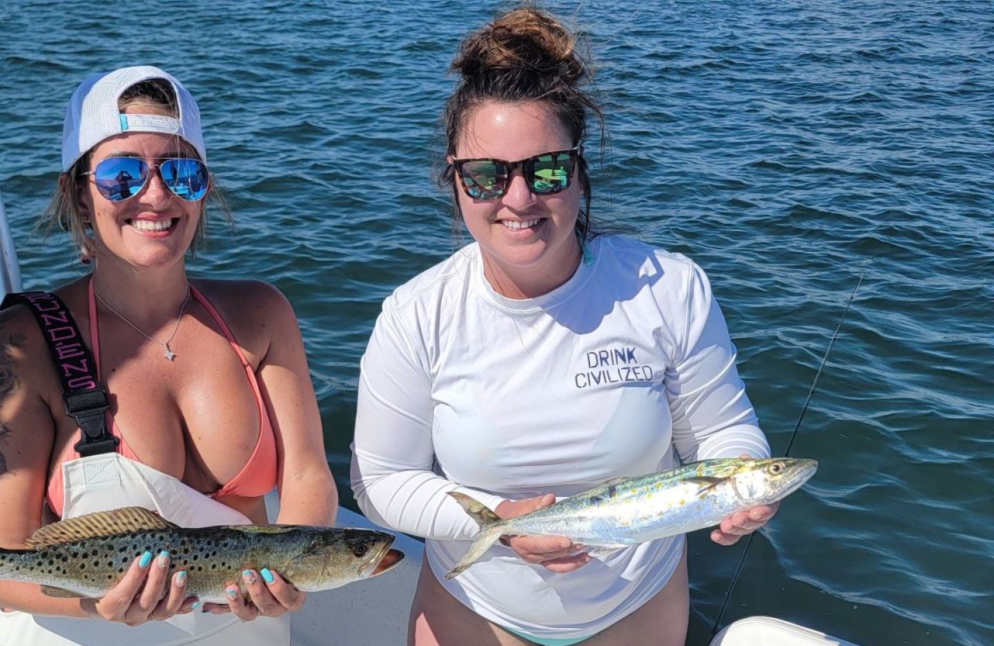 Two anglers holding Spanish Mackerel and Speckled Trout caught fishing in Crystal River FL