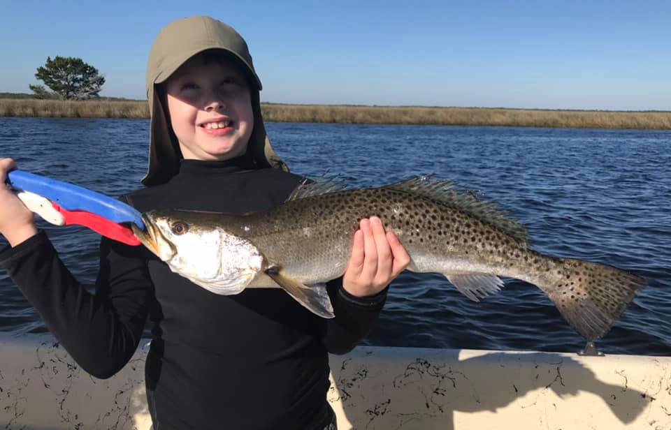 A fisherman catching a 26-inch spotted weakfish in St Marks