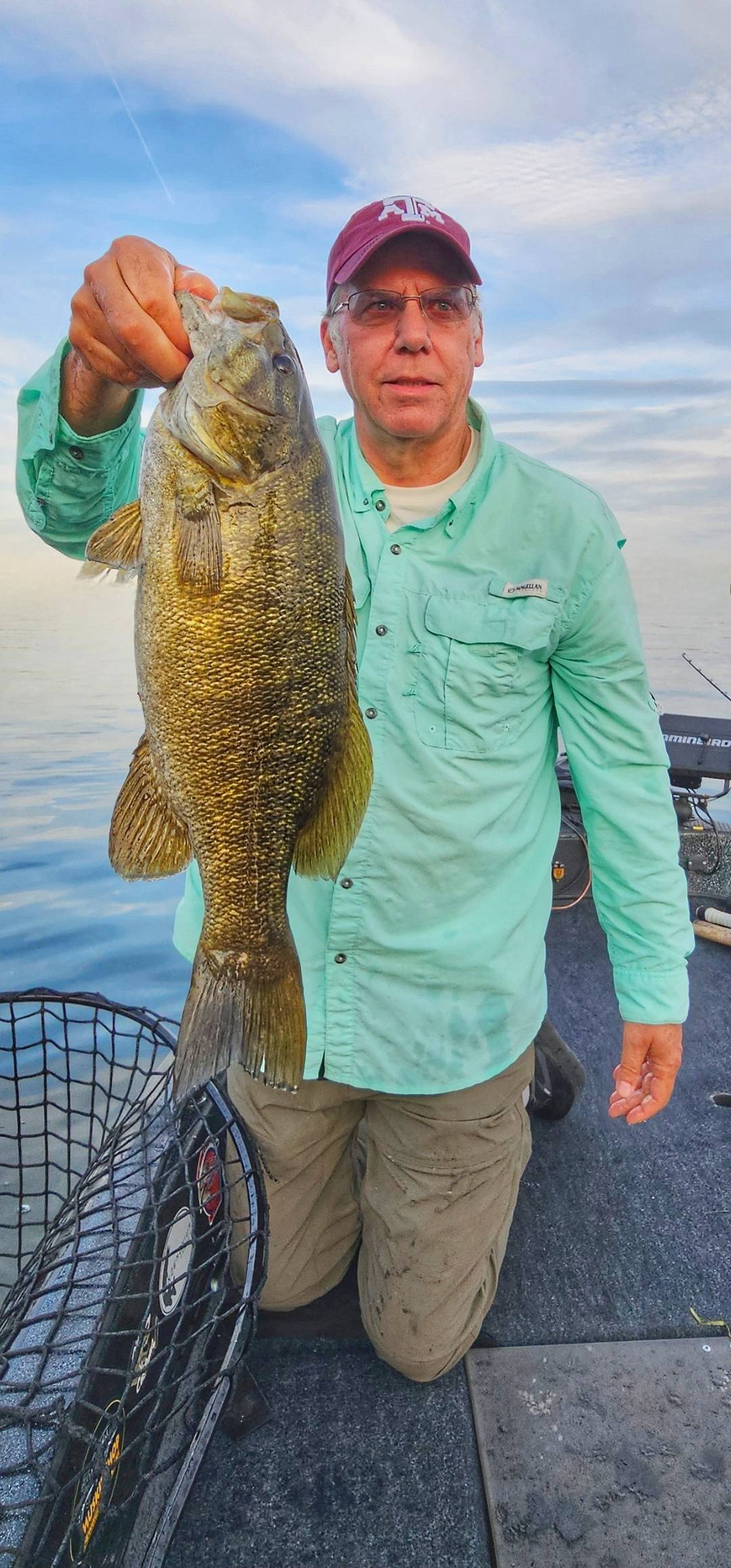 Smallmouth bass caught fishing in Waukesha Wisconsin held over boat deck