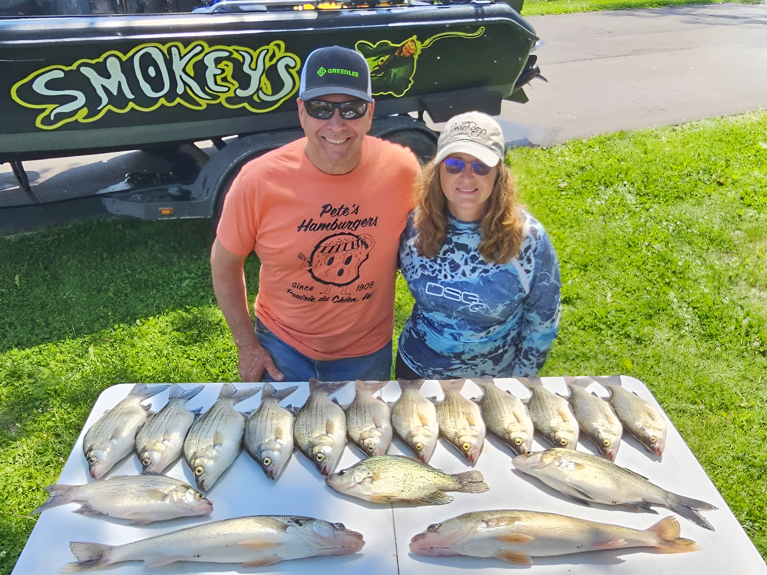 Fresh caught walleye and white bass displayed on table after successful fishing trip in Waukesha Wisconsin