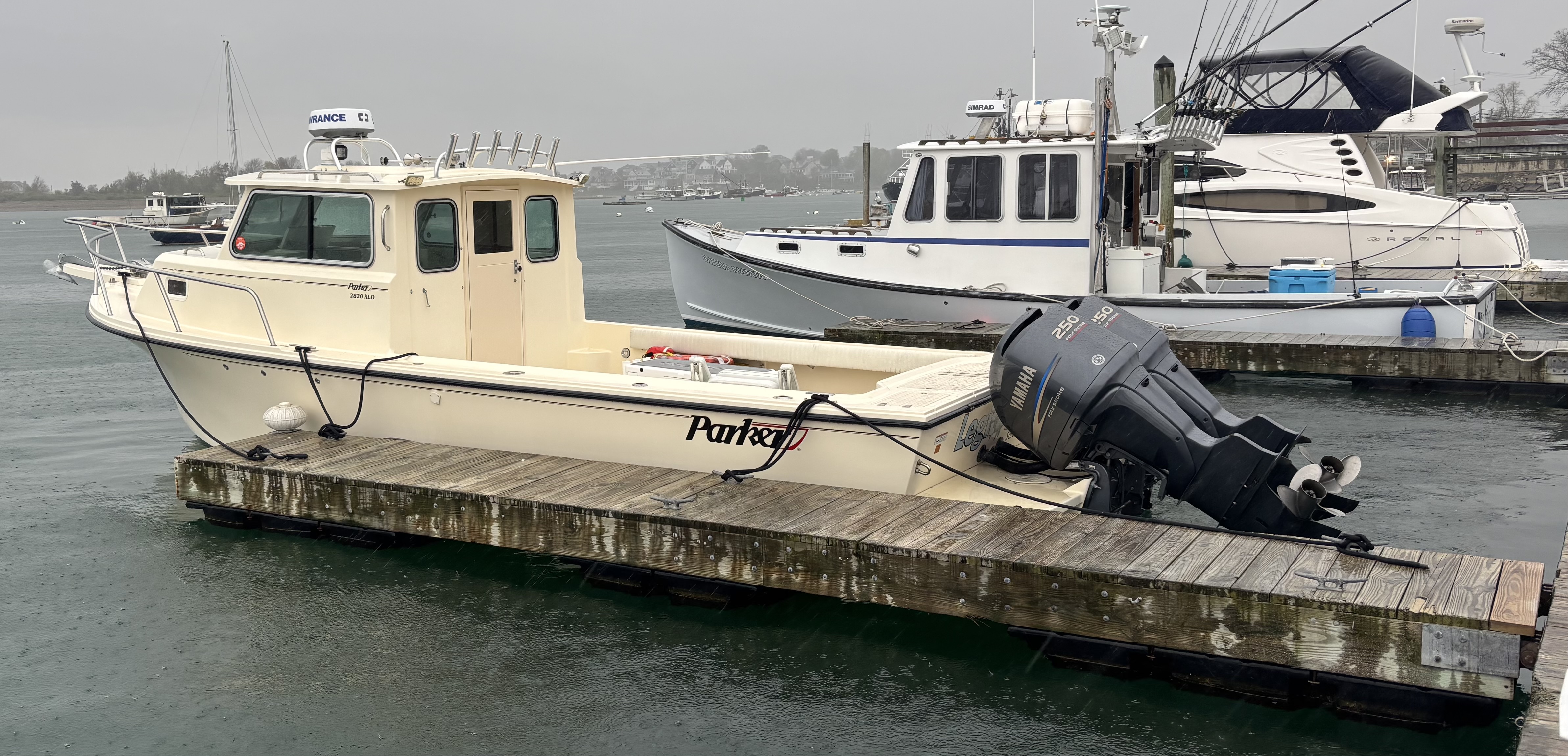 Fishing boat named Parker docked at marina in Scituate MA with outboard motor